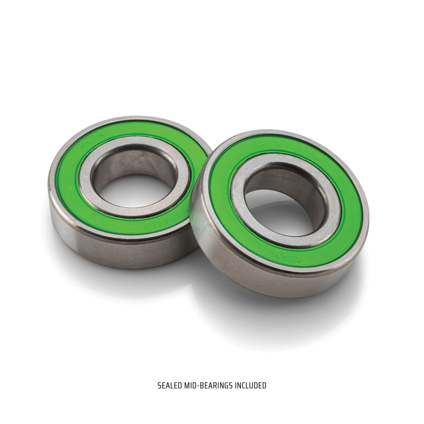 Two IKONIX crankset bearings with green rubber seals on a white background