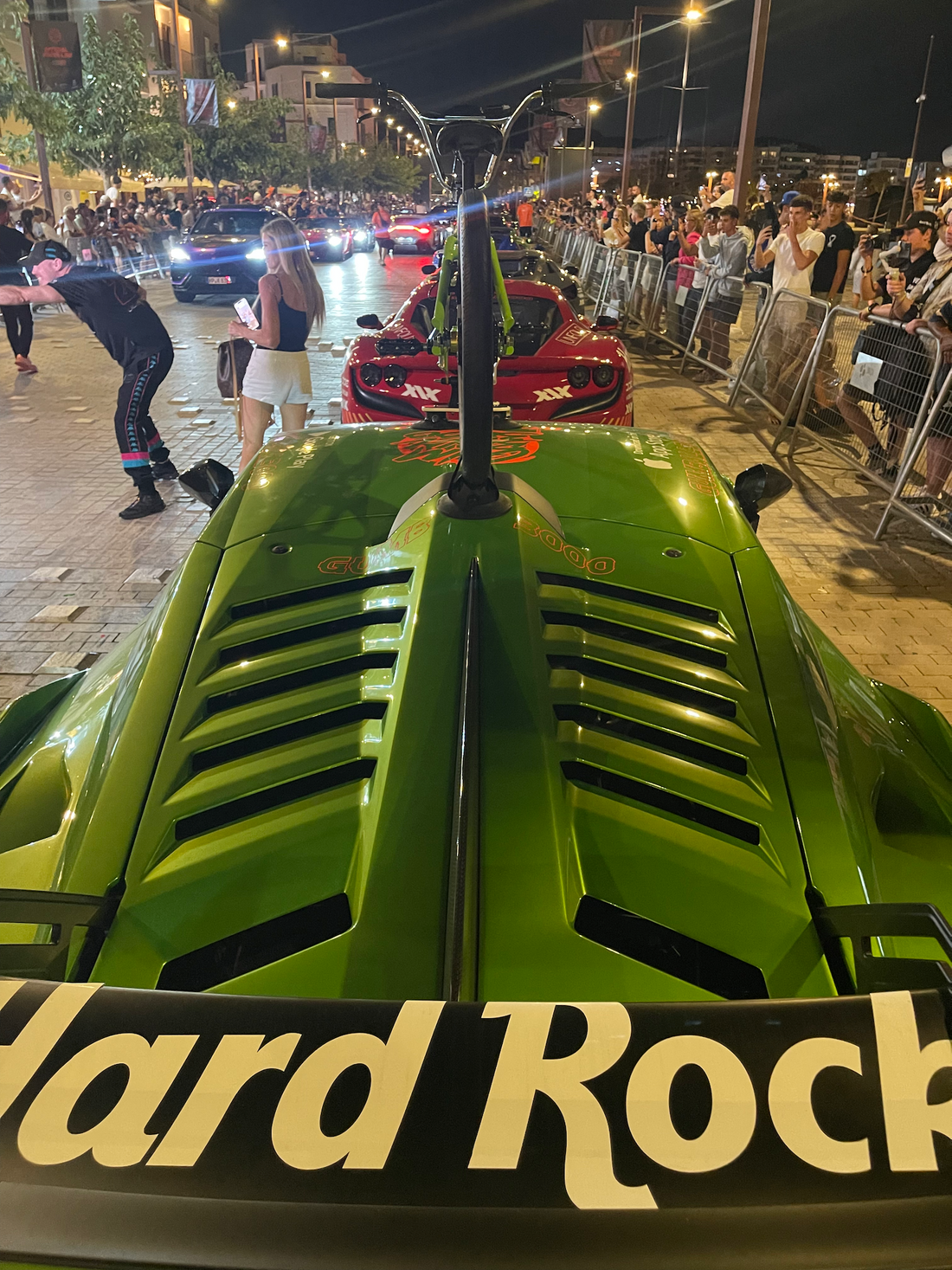 An IKONIX FS1 freestyle BMX bike atop a Lamborghini Huracán STO at the 2025 Gumball Rally